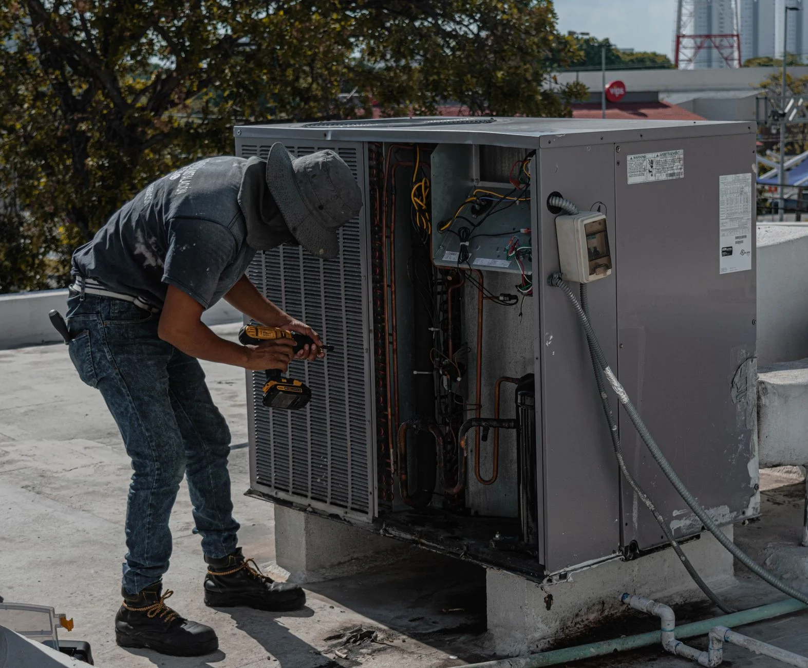Technician adjusting a smart thermostat
